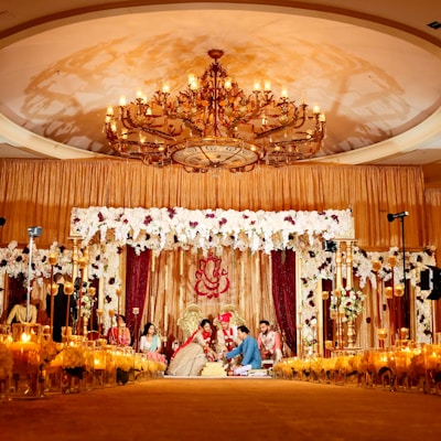 people standing in gold and white floral ceiling