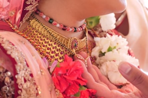woman wearing gold and pink beaded bracelet