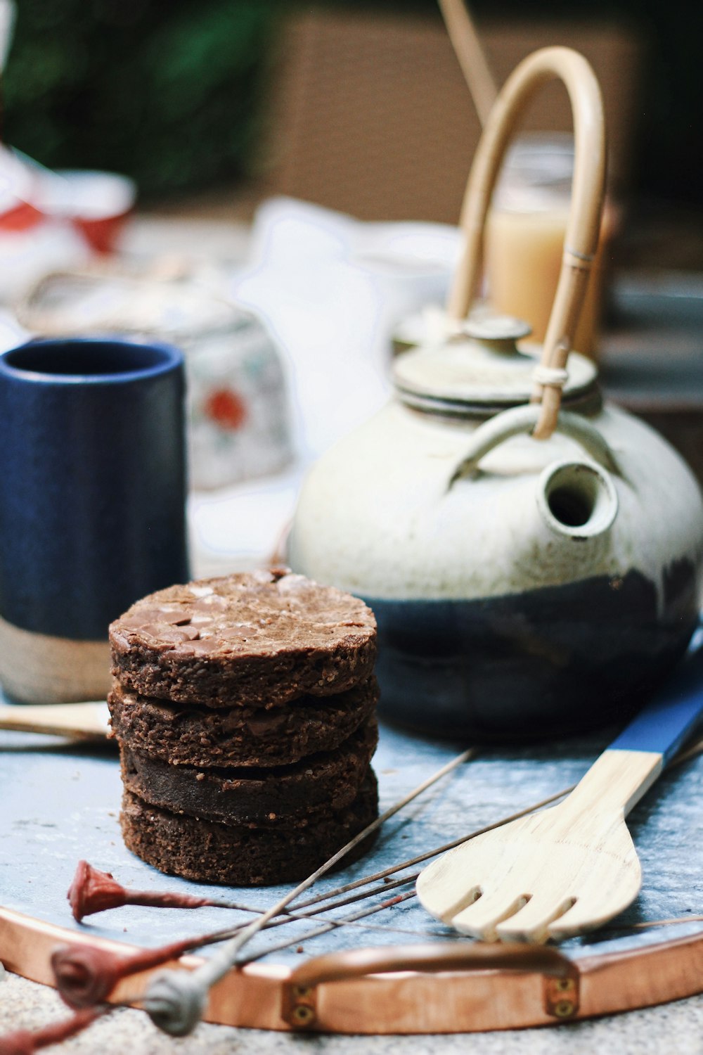 chocolate cookies on white paper beside brown wooden spoon