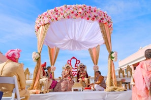 people sitting on chair under red and white floral umbrella