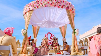 people sitting on chair under red and white floral umbrella