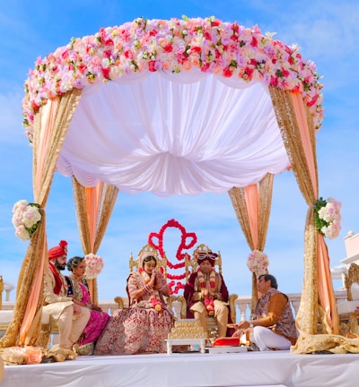 people sitting on chair under red and white floral umbrella