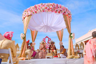 people sitting on chair under red and white floral umbrella