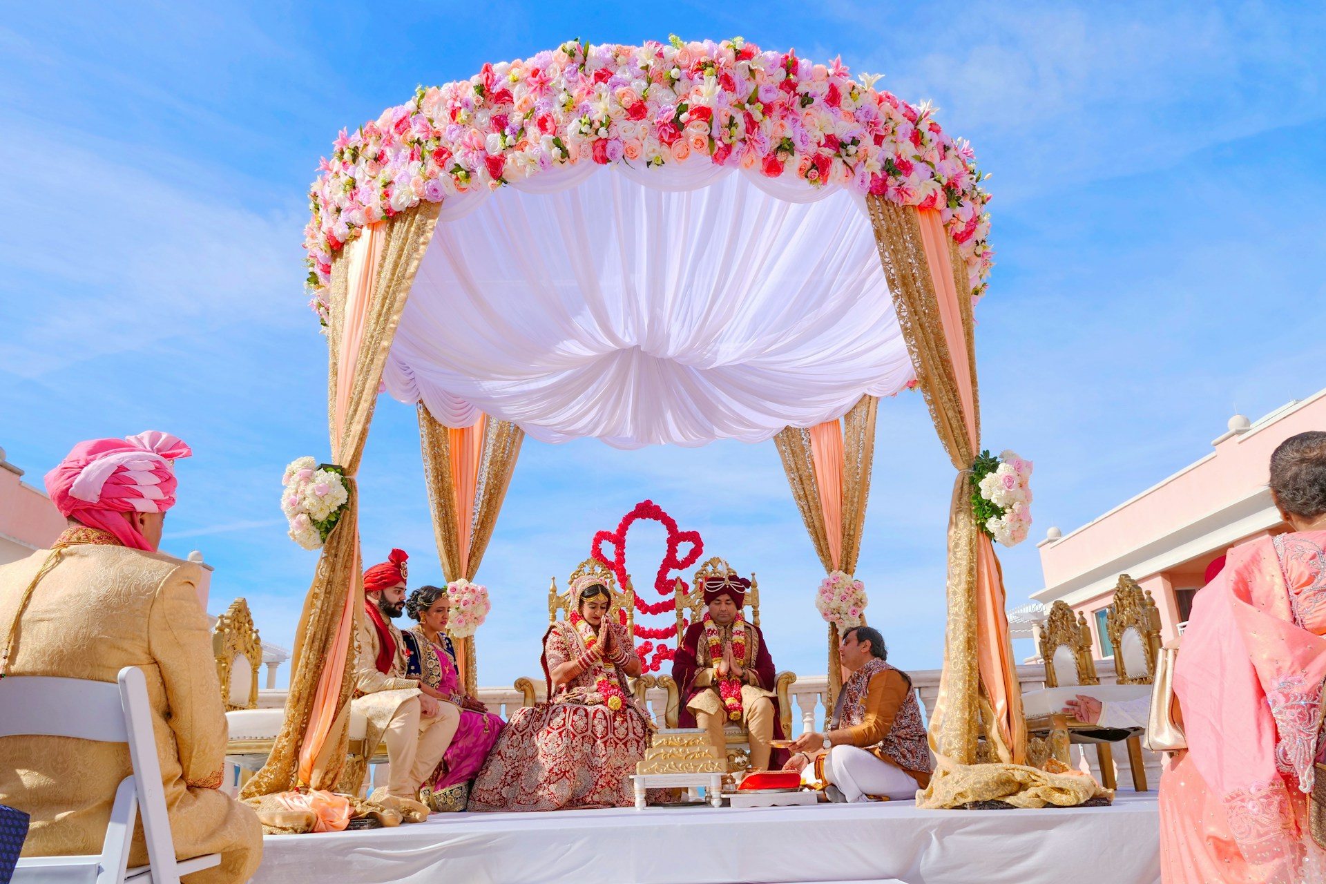 people sitting on chair under red and white floral umbrella