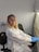 woman in white coat sitting on black chair