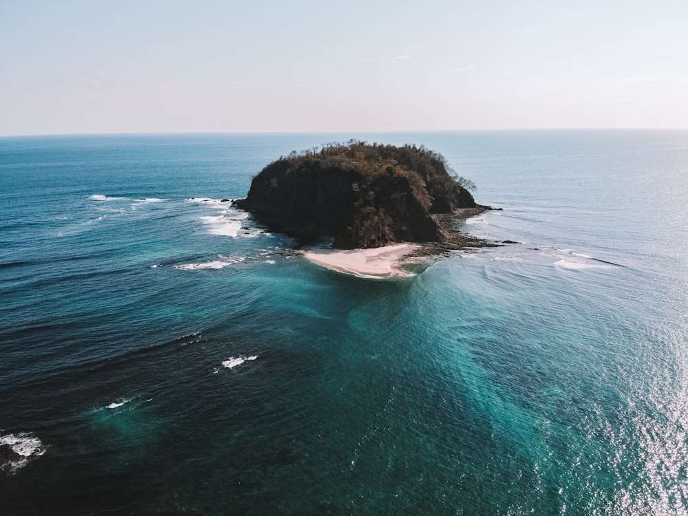 brown rock formation on sea during daytime