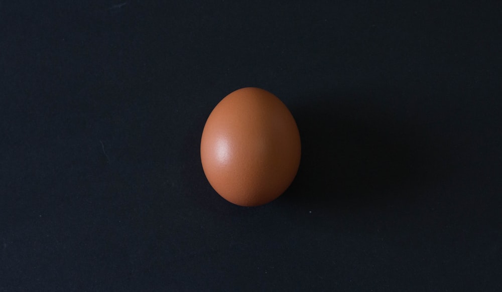 brown egg on black table