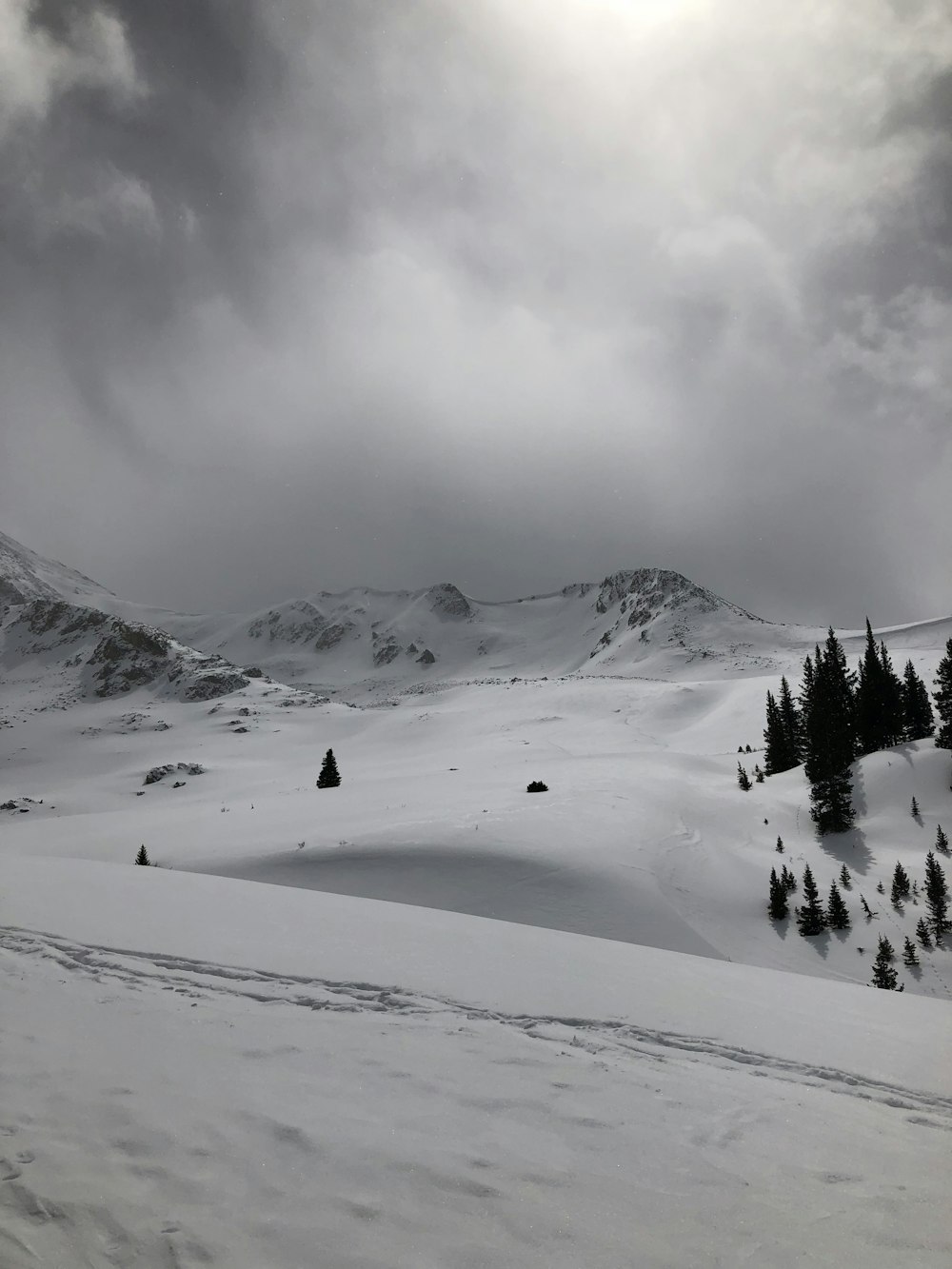 snow covered mountain under cloudy sky during daytime