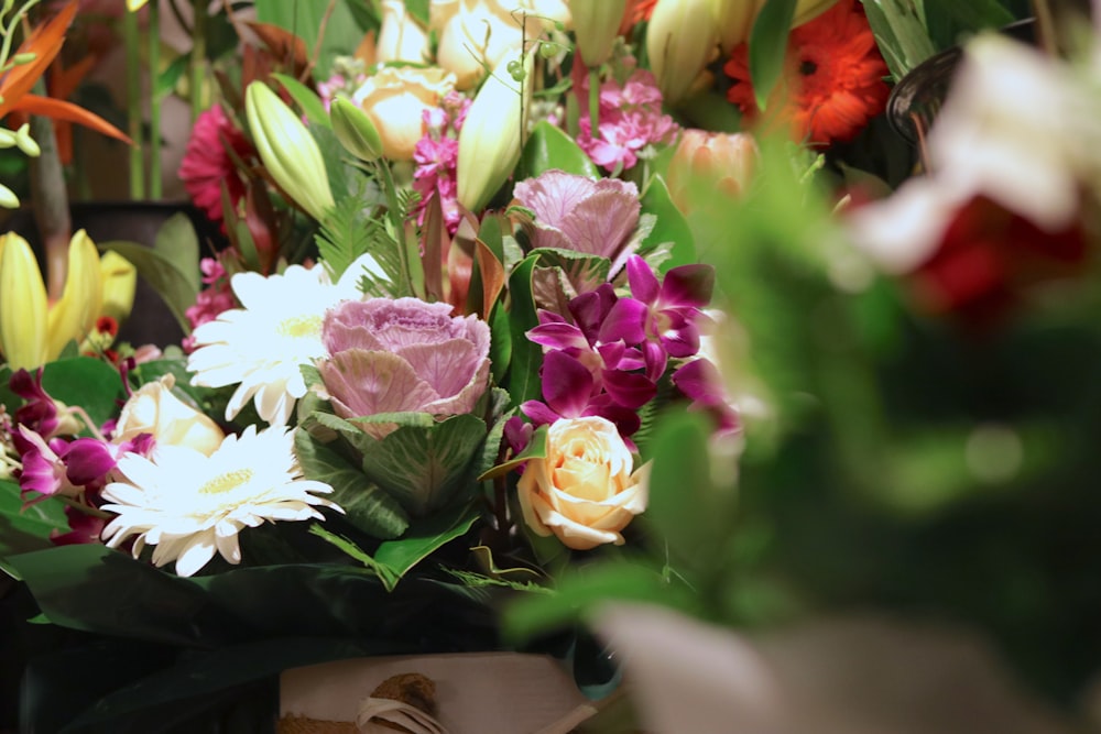 pink and white flowers on brown wooden table