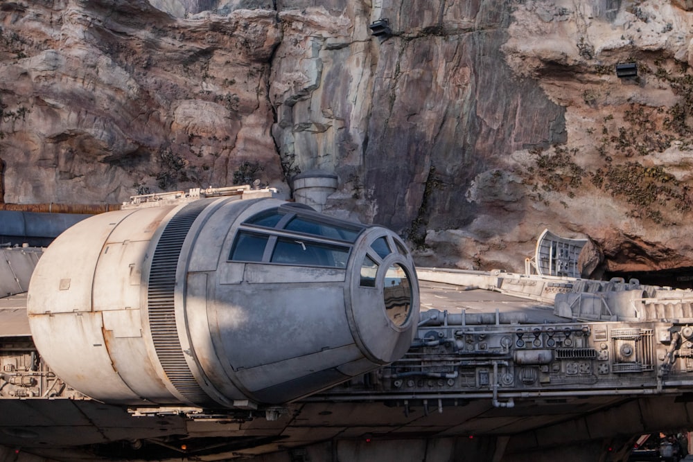 a close up of a large metal object near a mountain