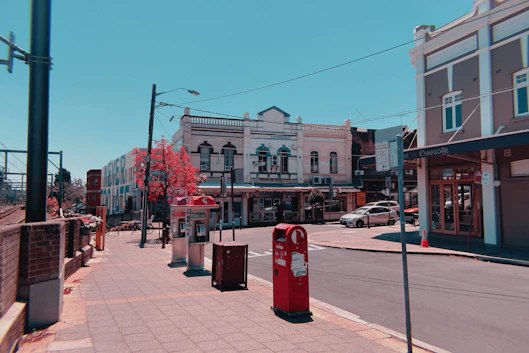 Sydney Inner West red Australia Post bins on sidewalk during daytime