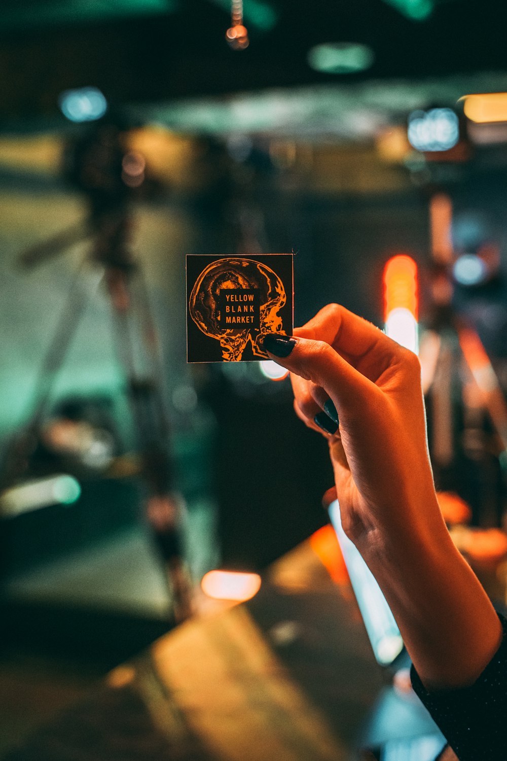 person holding black and orange box