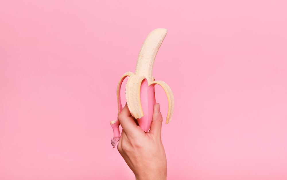 person holding sliced of banana