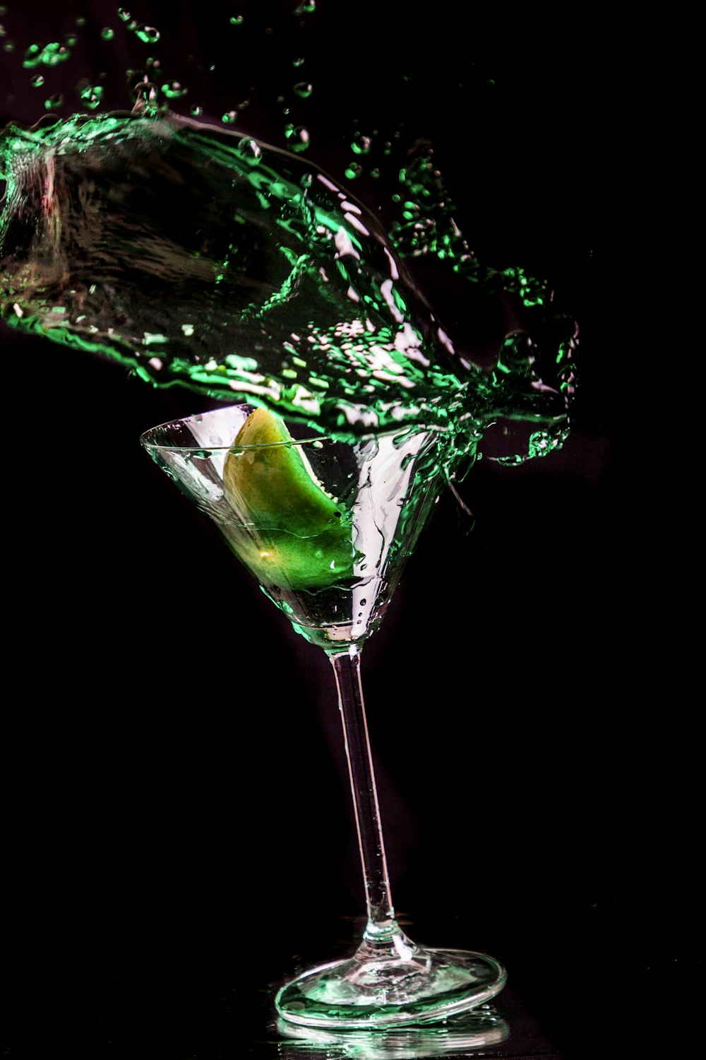 green liquid in clear cocktail glass