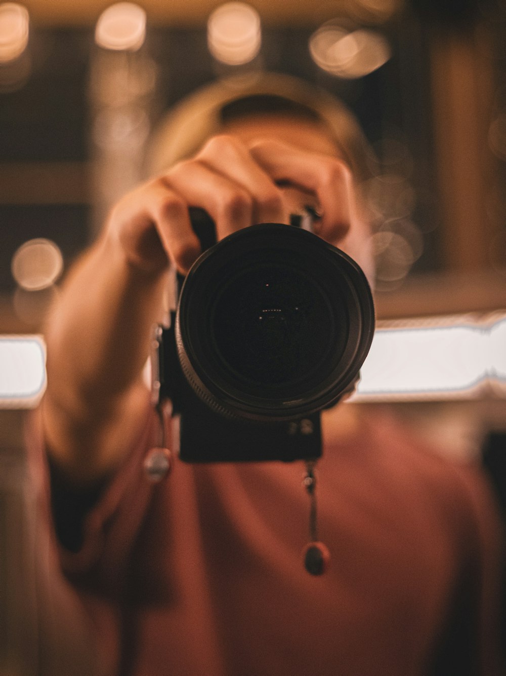 person holding black camera lens