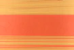 Overhead shot of colorful pasta shapes arranged neatly with measuring tools and fresh ingredients on a minimalist surface