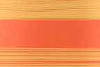 Overhead shot of colorful pasta shapes arranged neatly with measuring tools and fresh ingredients on a minimalist surface