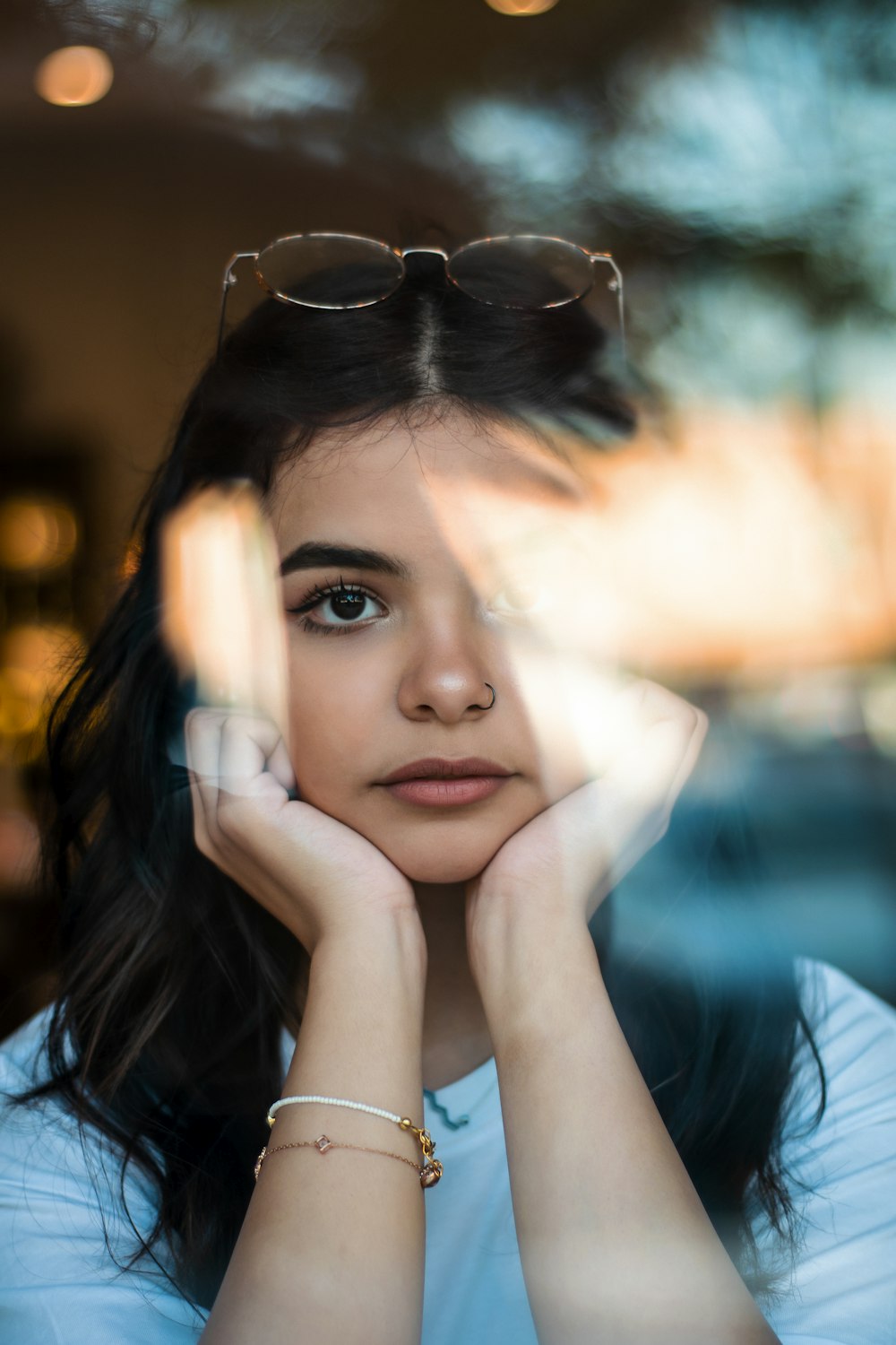 woman in blue shirt wearing black framed eyeglasses