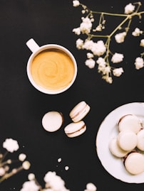 white ceramic mug with coffee on white ceramic saucer