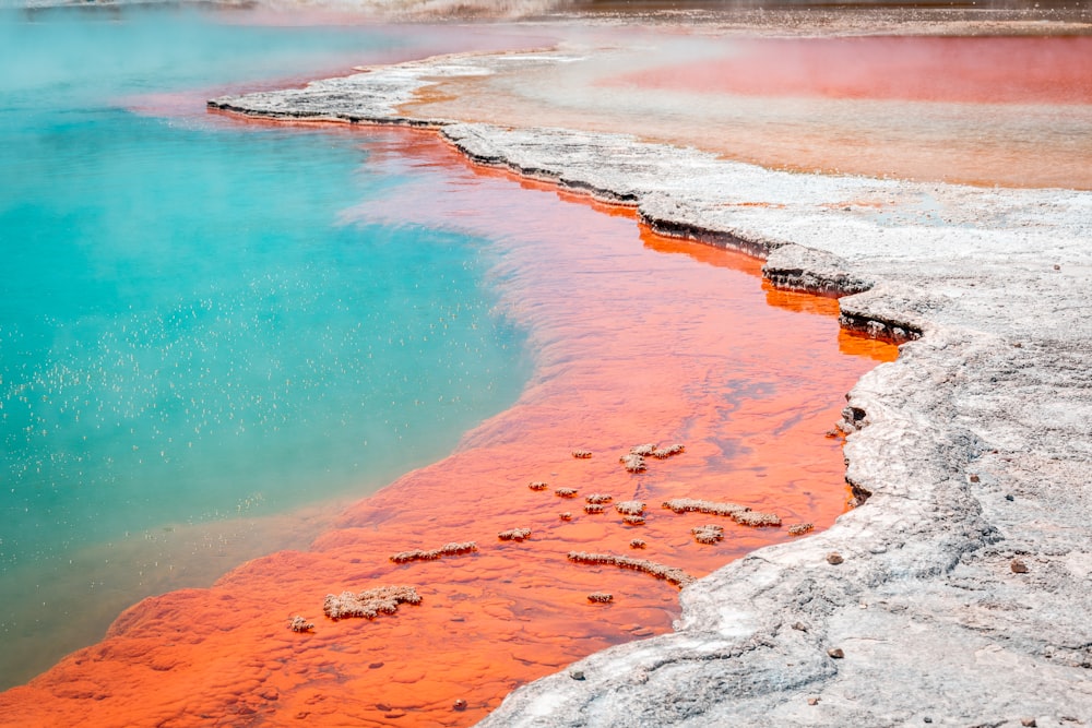 body of water near gray rock