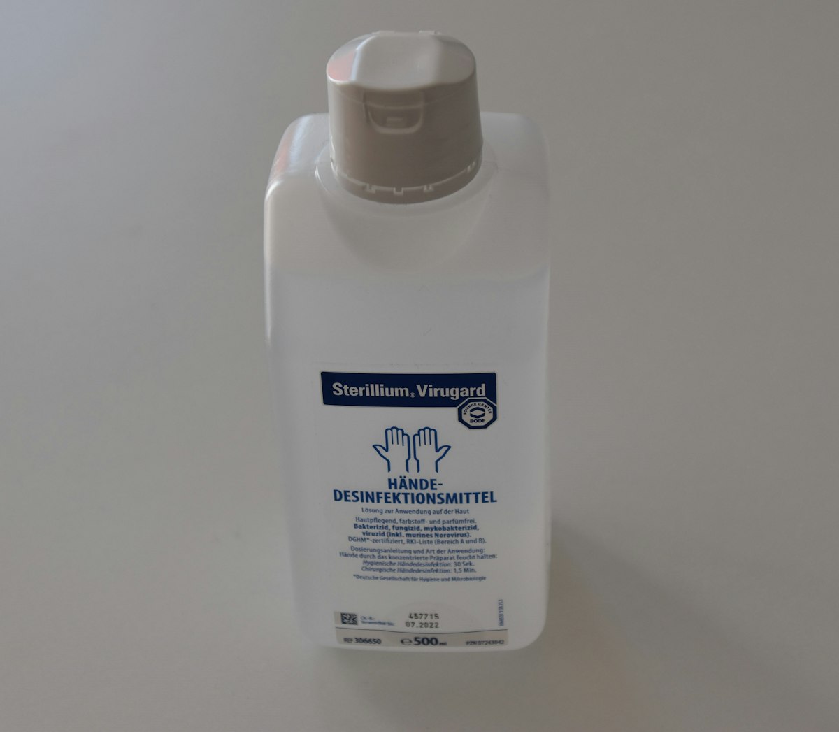 white plastic bottle on white table