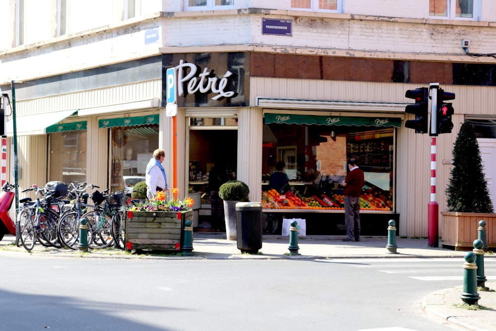 people sitting on bench in front of the UNKs restaurant