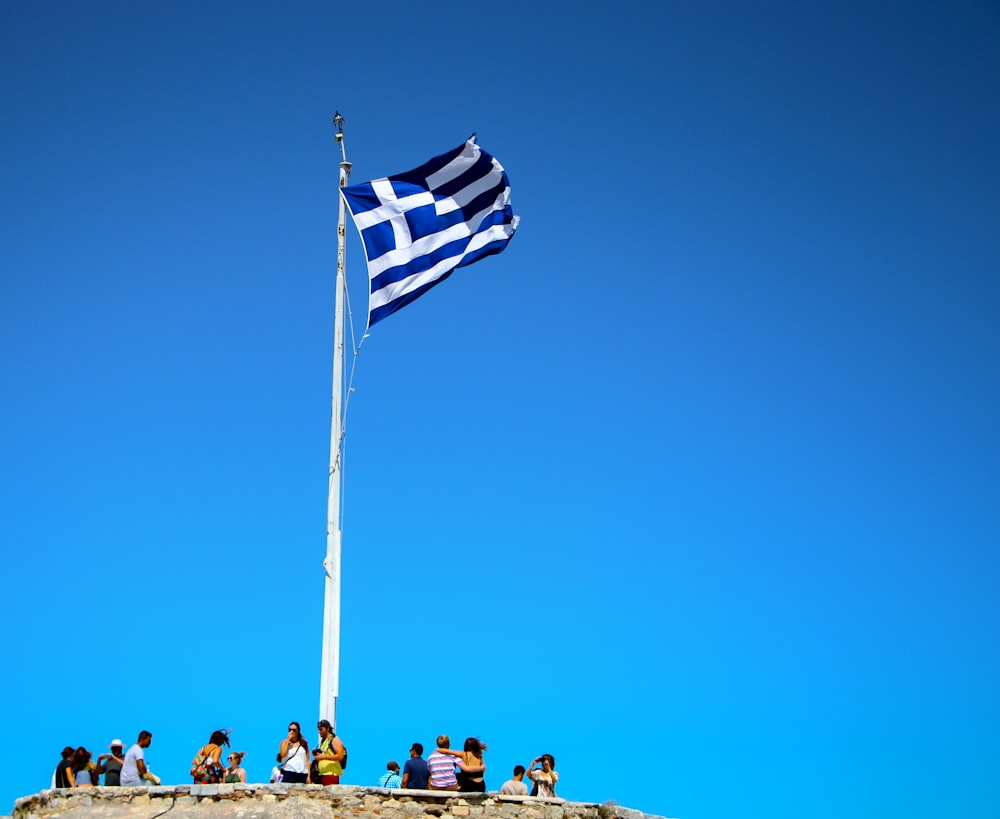 blue and white striped flag on pole during daytime