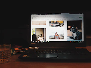 A person comparing car rental prices on a laptop with rental documents nearby