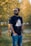 A casual outdoor scene featuring a man wearing a stylish t-shirt in a park.
