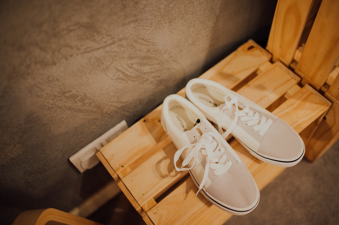 white low top sneakers on white plastic drawer