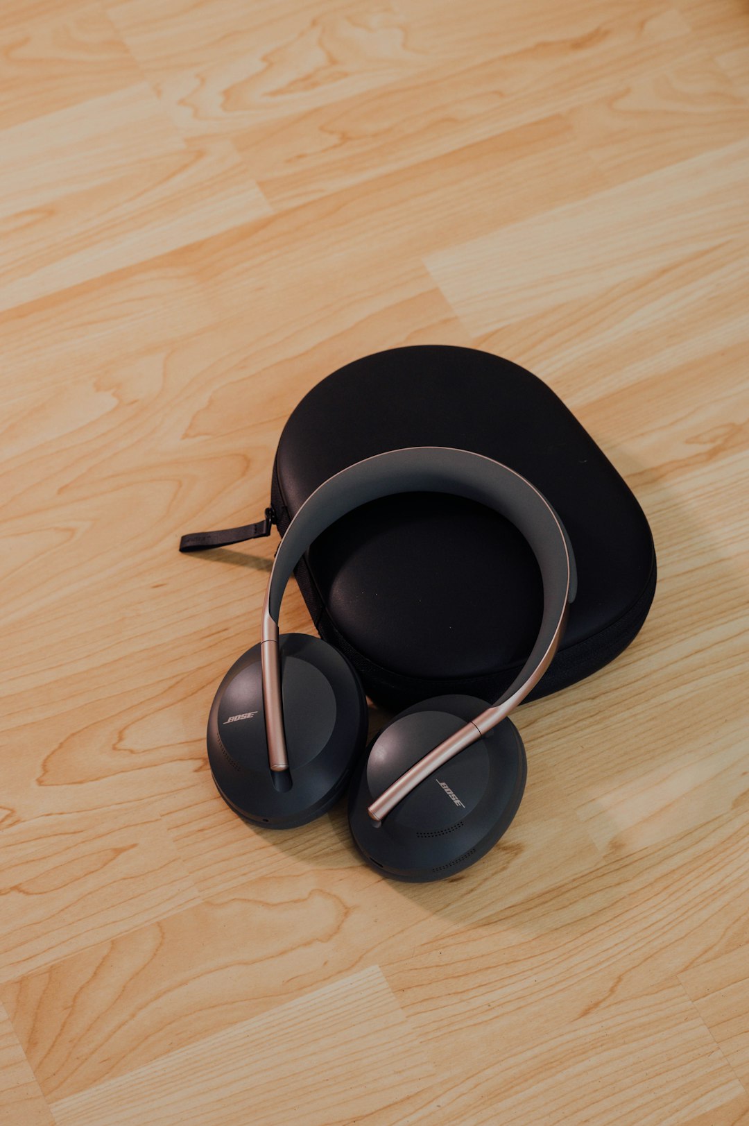 black and gray wireless headphones on black round pad