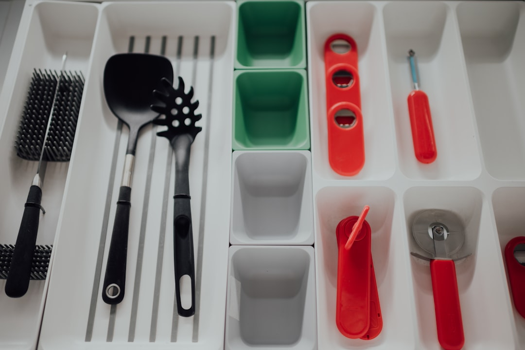 red handled spoon and fork on white plastic container