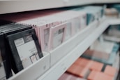 A selection of elegant photo frames displayed on a wooden shelf.