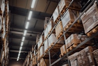 brown cardboard boxes on white metal rack