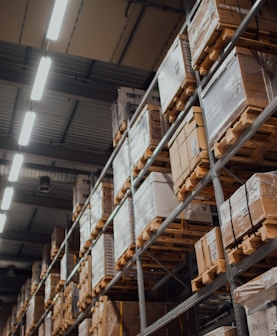 brown cardboard boxes on white metal rack