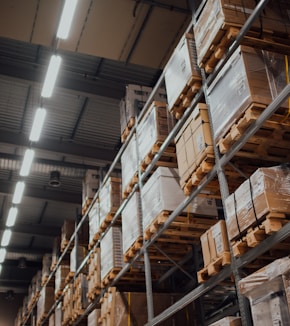 brown cardboard boxes on white metal rack