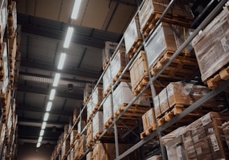 brown cardboard boxes on white metal rack