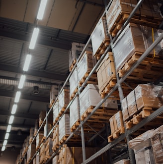 brown cardboard boxes on white metal rack