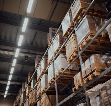 brown cardboard boxes on white metal rack