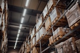 brown cardboard boxes on white metal rack