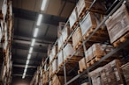 brown cardboard boxes on white metal rack