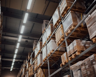 brown cardboard boxes on white metal rack