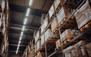 brown cardboard boxes on white metal rack