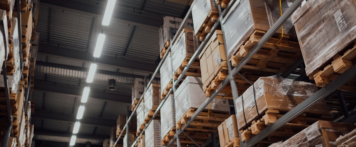 brown cardboard boxes on white metal rack