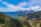Traveler admiring a breathtaking mountain landscape arranged by a personalized travel service.