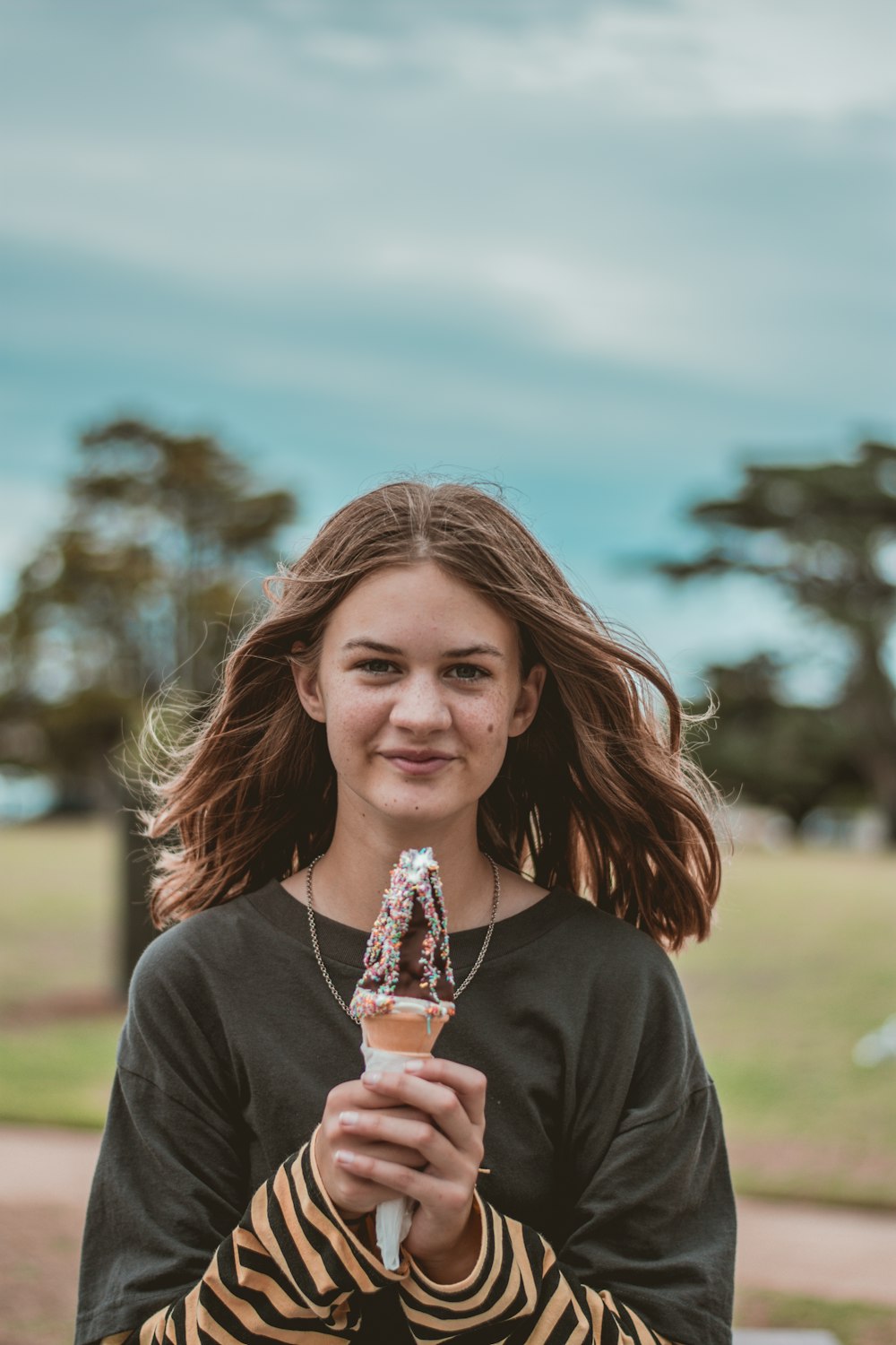 woman in black crew neck shirt holding ice cream