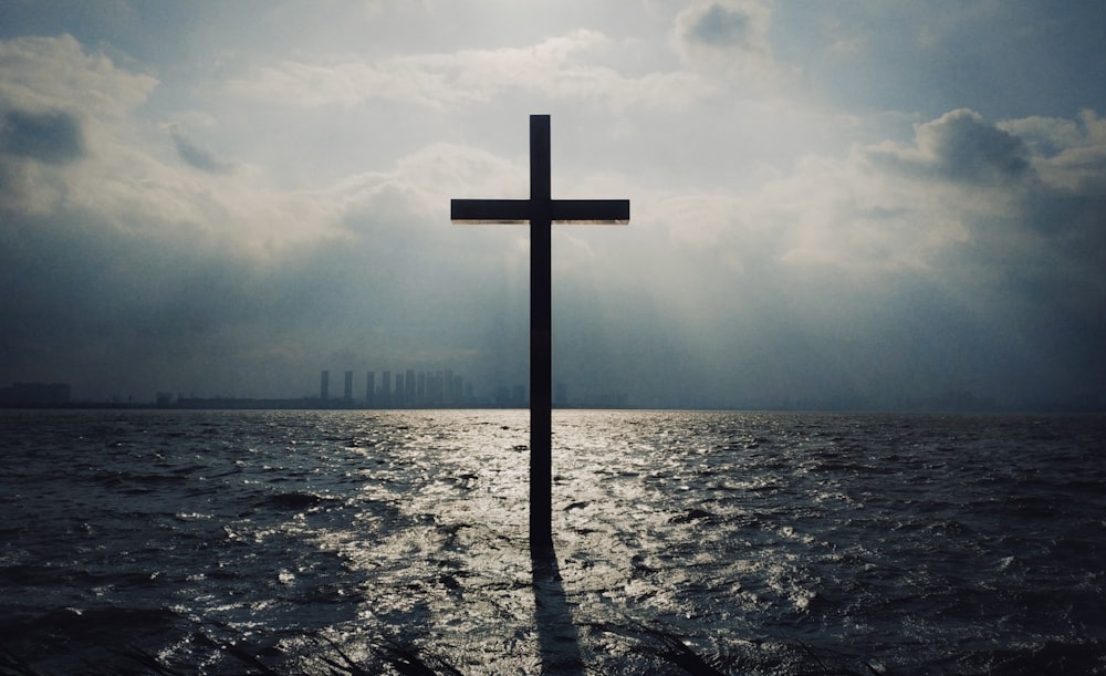 brown wooden cross on beach during daytime