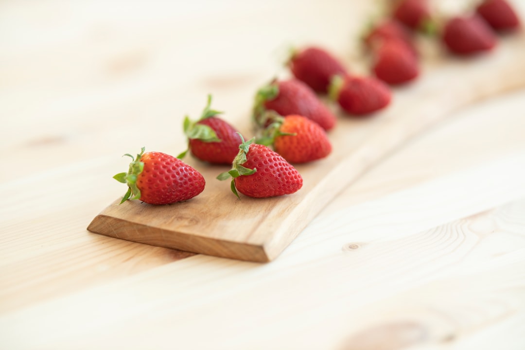 red strawberries on brown wooden chopping board