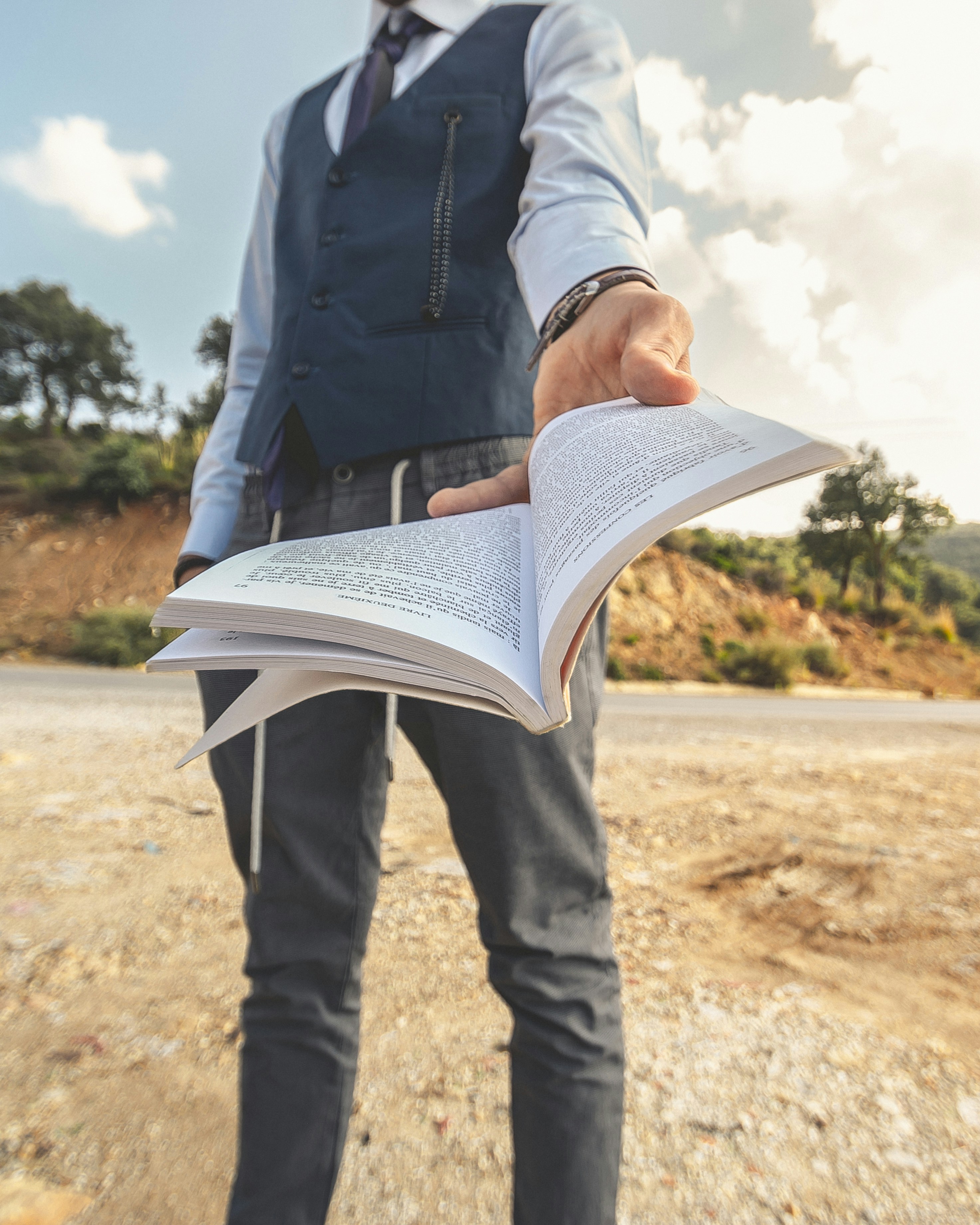 Man in black jacket and black pants reading book photo Free Shooting