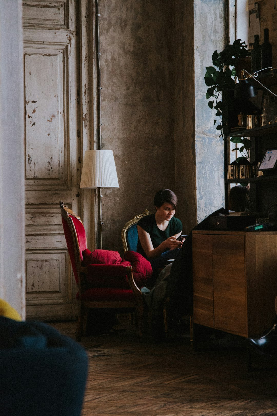 man in red t-shirt sitting on red chair